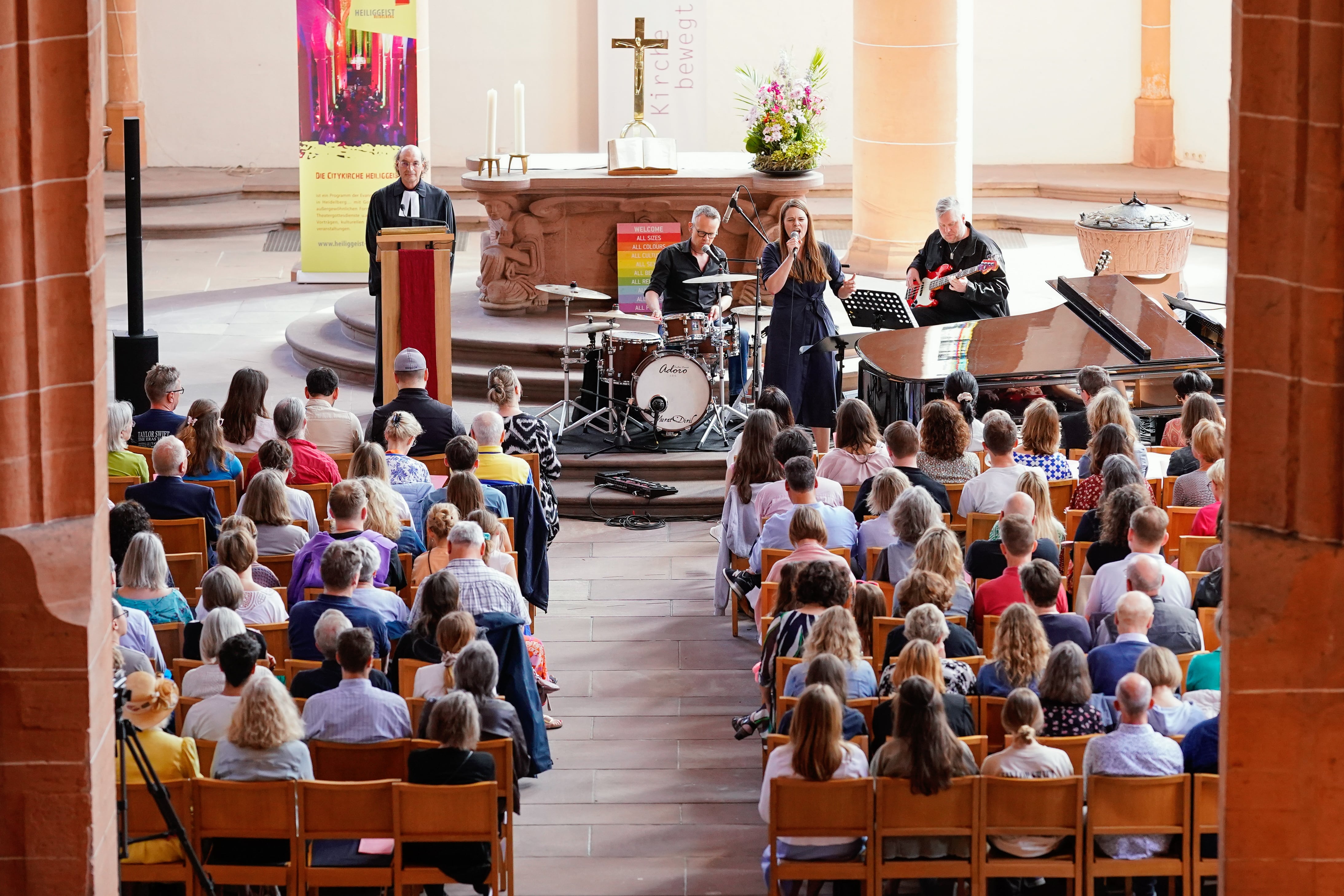 12 May 2024, Baden-Württemberg, Heidelberg: Singer Tine Wiechmann performs in the Heiliggeistkirche during a Taylor Swift service. Pastor Vincenzo Petracca is on the left. The artist sang six of the pop star's songs with her band. The two masses entitled "Anti Hero" after the song "Anti-Hero" by Swift were fully booked. Photo: Uwe Anspach/dpa (Photo by Uwe Anspach/picture alliance via Getty Images)