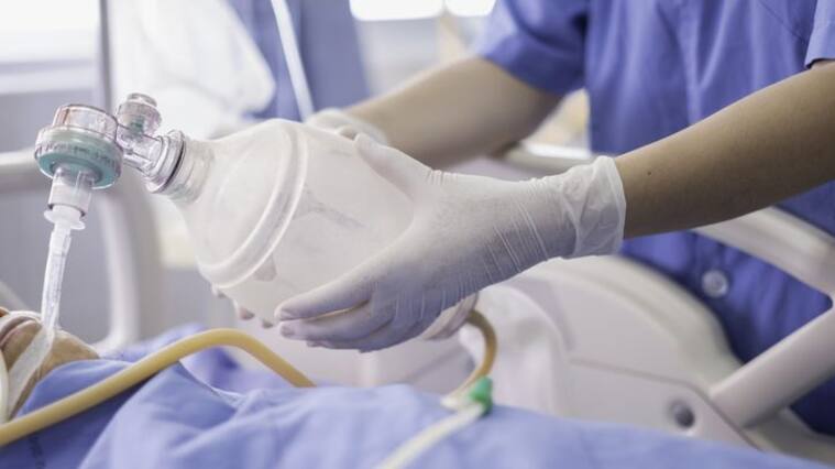 doctor holding oxygen ambu bag over patient given oxygen to patient by intubation tube in ICU/Emergency room