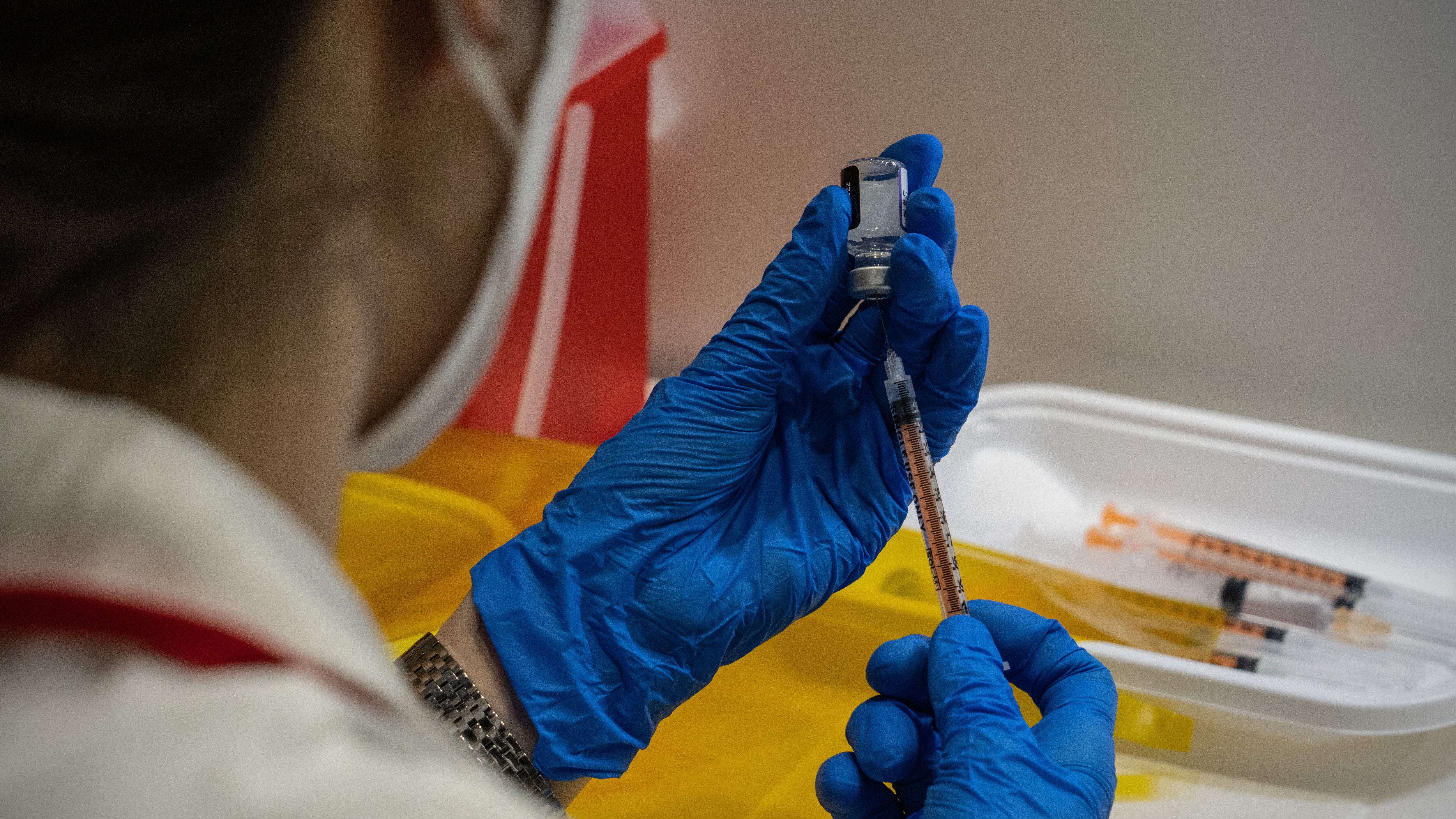 TOKYO, JAPAN - JANUARY 20: A nurse prepares syringes with the Pfizer coronavirus booster vaccination on January 20, 2022 in Tokyo, Japan. Tokyo Metropolitan Government recorded 8,638 new Covid-19 infections today, the highest ever for the city. However, the number of people hospitalised with severe symptoms has dropped from ten to nine. (Photo by Carl Court/Getty Images)