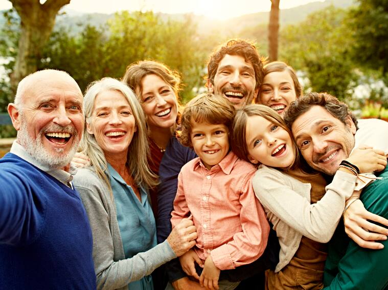Group selfie of cheerful multi-generation family at yard