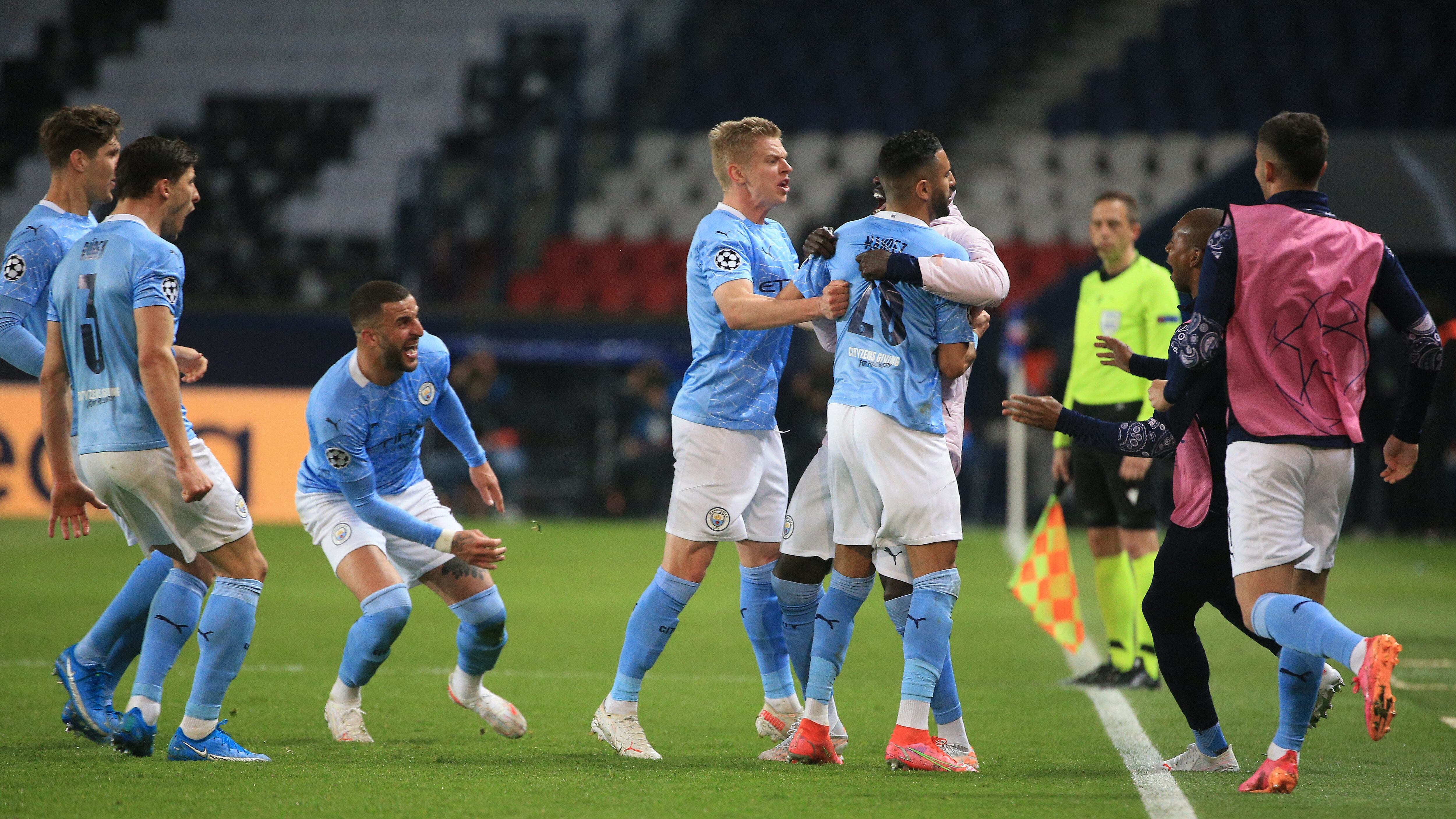 PARIS, FRANCE - APRIL 28: Riyad Mahrez of Manchester City celebrates with Oleksandr Zinchenko and Benjamin Mendy after scoring their side's second goal during the UEFA Champions League Semi Final First Leg match between Paris Saint-Germain and Manchester City at Parc des Princes on April 28, 2021 in Paris, France. Sporting stadiums around France remain under strict restrictions due to the Coronavirus Pandemic as Government social distancing laws prohibit fans inside venues resulting in games being played behind closed doors. (Photo by Tom Flathers/Manchester City FC via Getty Images)
