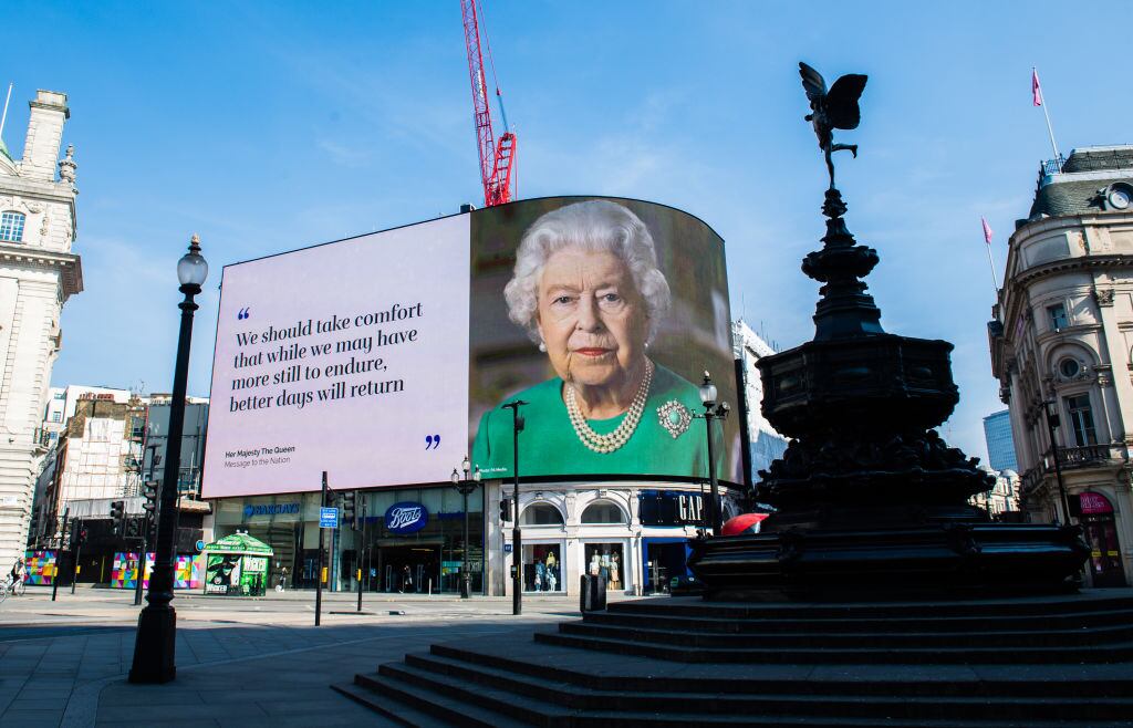 LONDON, ENGLAND - APRIL 10: An image of Queen Elizabeth II and quotes from her broadcast to the nation in relation to the coronavirus epidemic are displayed on screens in Piccadilly Circus on April 10, 2020 in London, England. (Photo by Samir Hussein/WireImage,)