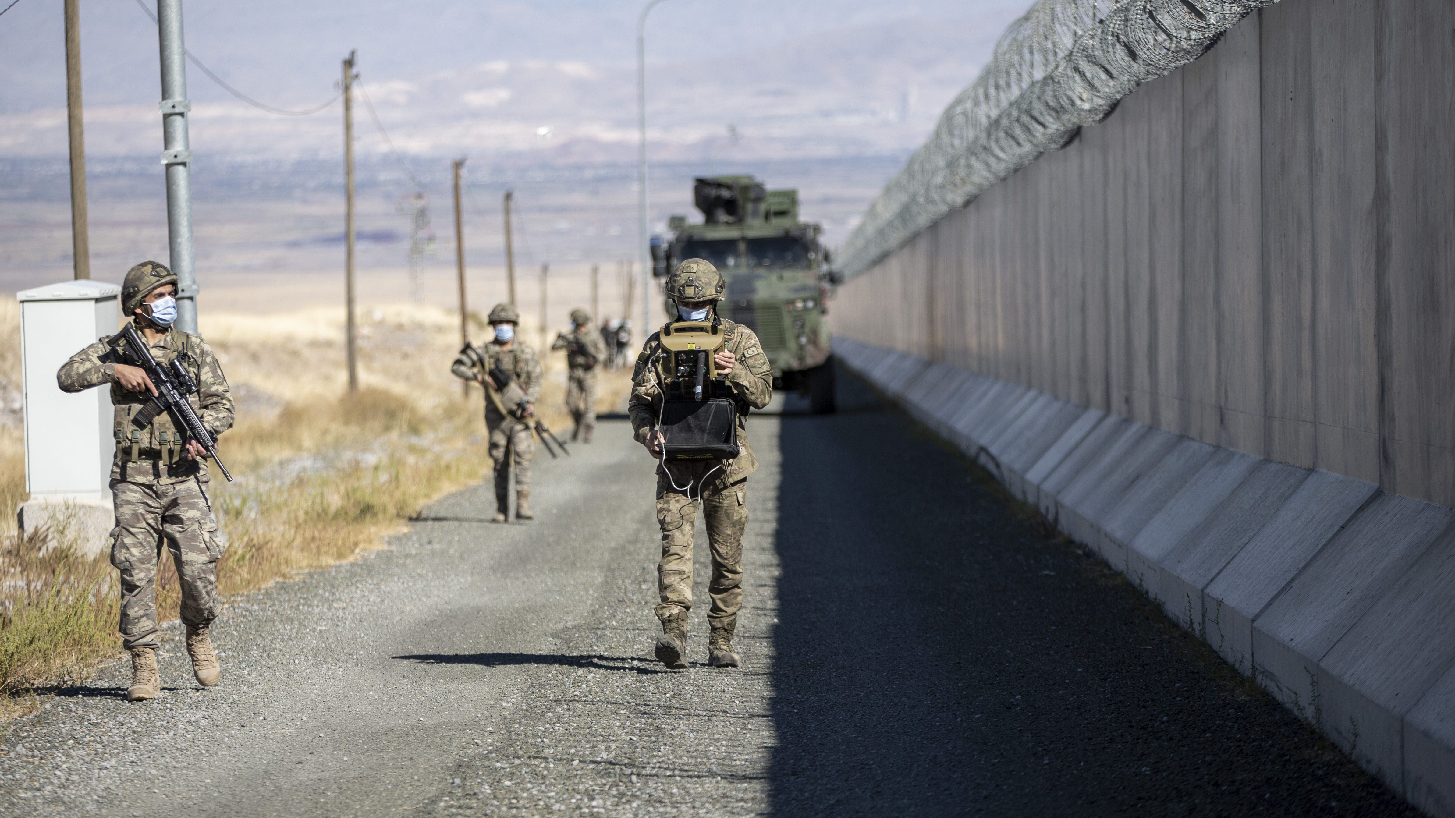 IGDIR, TURKEY - NOVEMBER 13: Turkish soldiers patrol near the security wall in Igdir, Turkey on November 13, 2021. The 145-kilometer concrete wall prevents irregular migrants and smugglers and especially terrorists, from entering the country. (Photo by Hilmi Tunahan Karakaya/Anadolu Agency via Getty Images)