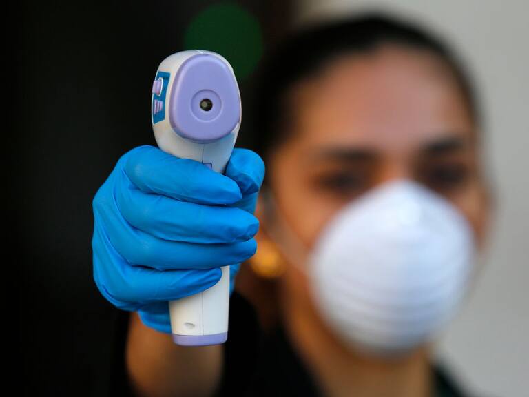 SANTIAGO, CHILE - MARCH 17: A security police officer controls the temperature of government officials at the entrance to the La Moneda presidential palace as the Chilean government takes measures to control the spread of the coronavirus on March 17, 2020 in Santiago, Chile. Earlier today, Health minister Jaime Mañalich informed there are 181 positive cases of COVID-19 in the country. According to WHO, Chile is the second country with more cases after Brazil. National Government had announced entry restrictions for its ports, airports and international crossings. (Photo by Marcelo Hernandez/Getty Images)