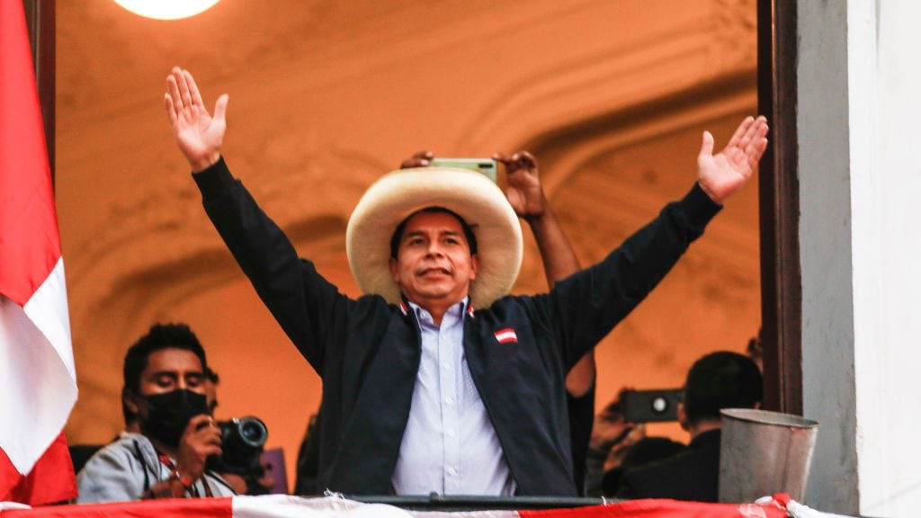 LIMA, PERU - JUNE 07: Presidential candidate Pedro Castillo of Peru Libre waves supporters at his political party's headquarters balcony after a tight runoff against presidential candidate for Fuerza Popular Keiko Fujimori on June 7, 2021 in Lima, Peru. With 96% of the votes reviewed, Castillo leads with 50.3%. (Photo by Ricardo Moreira/Getty Images)
