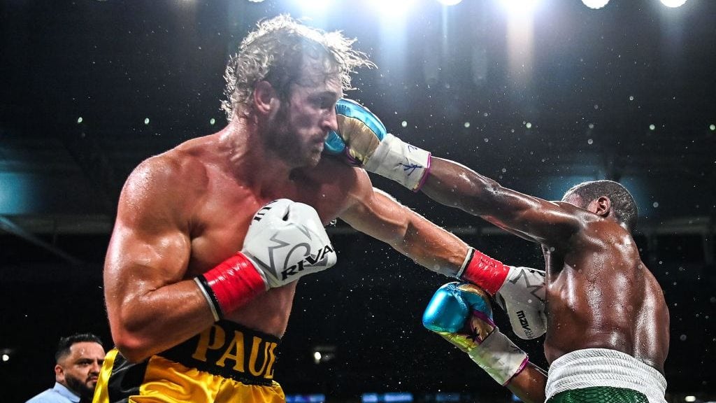 Former world welterweight king Floyd Mayweather (R) and YouTube personality Logan Paul (L) fight in an eight-round exhibition bout at Hard Rock Stadium in Miami, Florida on June 6, 2021. - Floyd Mayweather predictably dominated YouTube star Logan Paul on Sunday night in an eight round exhibition fight at Hard Rock Stadium in Miami, Florida.Mayweather, who weighed in at 155 lbs with his opponent tipping the scales at 189.5 lbs, produced a typically slick performance much to the delight of a substantial crowd at the home of the Miami Dolphins. (Photo by CHANDAN KHANNA / AFP) (Photo by CHANDAN KHANNA/AFP via Getty Images)