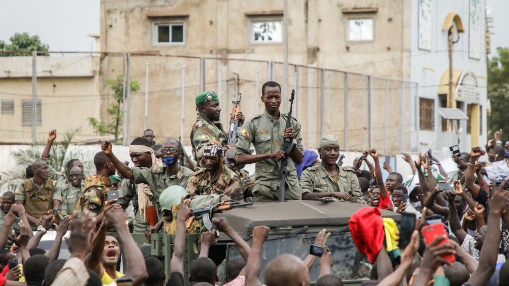 Armed members of the FAMA (Malian Armed Forces) are celebrated by the population as they parade at Independence Square in Bamako on August 18, 2020, after rebel troops seized Malian President Ibrahim Boubacar Keita and Prime Minister Boubou Cisse in a dramatic escalation of a months-long crisis. - Neighbouring states in West Africa, along with France, the European Union and the African Union, condemned the sudden mutiny and warned against any unconstitutional change of power in the fragile country. (Photo by STRINGER / AFP) (Photo by STRINGER/AFP via Getty Images)