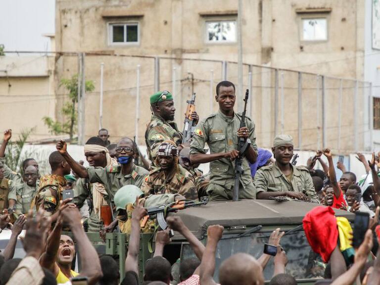 Armed members of the FAMA (Malian Armed Forces) are celebrated by the population as they parade at Independence Square in Bamako on August 18, 2020, after rebel troops seized Malian President Ibrahim Boubacar Keita and Prime Minister Boubou Cisse in a dramatic escalation of a months-long crisis. - Neighbouring states in West Africa, along with France, the European Union and the African Union, condemned the sudden mutiny and warned against any unconstitutional change of power in the fragile country. (Photo by STRINGER / AFP) (Photo by STRINGER/AFP via Getty Images)