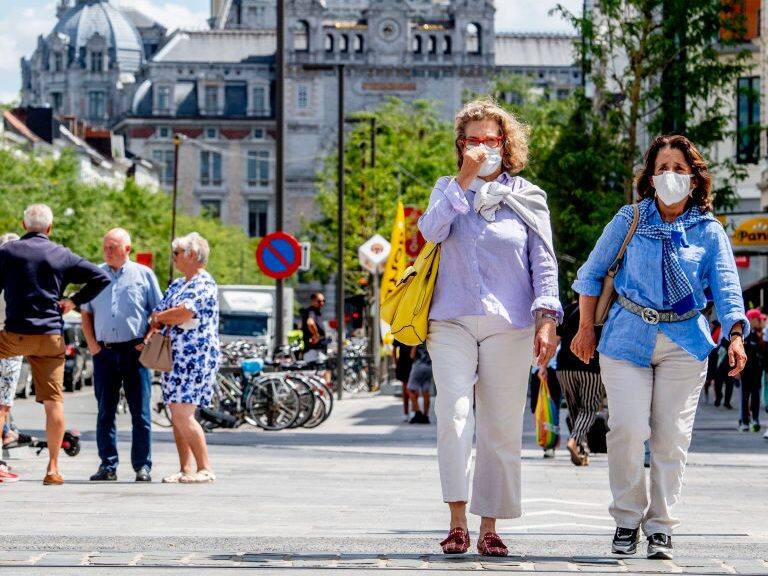 ANTWERP, BELGIUM - 2020/07/20: People wearing face masks as a preventive measure walk on the street during the coronavirus crisis.The wearing of a face mask will become compulsory from Saturday in shops and some other indoor spaces where people gather. (Photo by Robin Utrecht/SOPA Images/LightRocket via Getty Images)
