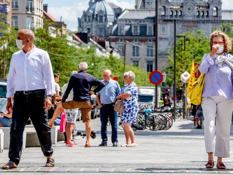 ANTWERP, BELGIUM - 2020/07/20: People wearing face masks as a preventive measure walk on the street during the coronavirus crisis.The wearing of a face mask will become compulsory from Saturday in shops and some other indoor spaces where people gather. (Photo by Robin Utrecht/SOPA Images/LightRocket via Getty Images)