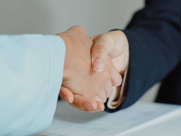 Closeup of young Asian woman pass job interview sit in front of HR manager and shake hands at office. Human resource, Recruitment agency concept.