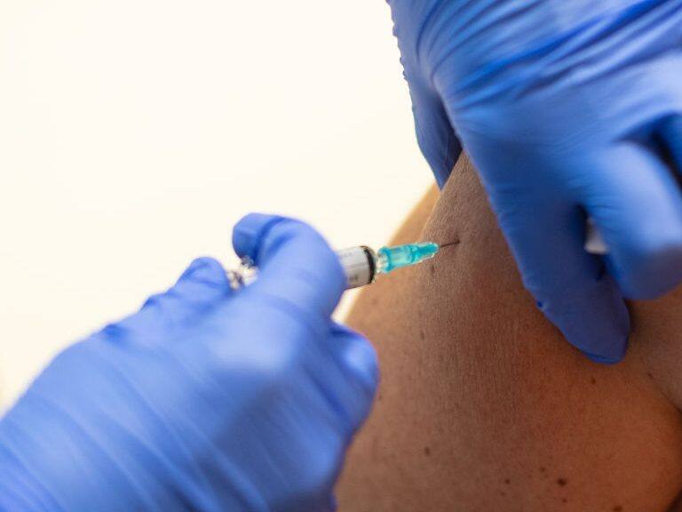 BARCELONA, SPAIN - OCTOBER 16: A health care worker administers a flu vaccine to a woman at a temporary vaccination centre during the second wave of Coronavirus (COVID-19) pandemic on October 16, 2020 in Barcelona, Spain. Catalan regional government started yesterday an early flu vaccine campaign as a measure against the coronavirus pandemic. (Photo by David Ramos/Getty Images)
