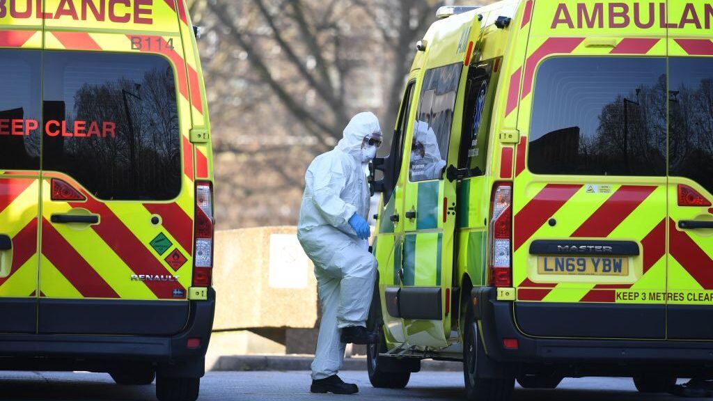 A member of the ambulance service wearing personal protective equipment is seen leading a patient (unseen) into an ambulance at St Thomas' Hospital in London on March 24, 2020. - Britain's leaders on Tuesday urged people to respect an unprecedented countrywide lockdown, saying that following advice to stay at home would stop people dying of coronavirus. (Photo by DANIEL LEAL-OLIVAS / AFP) (Photo by DANIEL LEAL-OLIVAS/AFP via Getty Images)