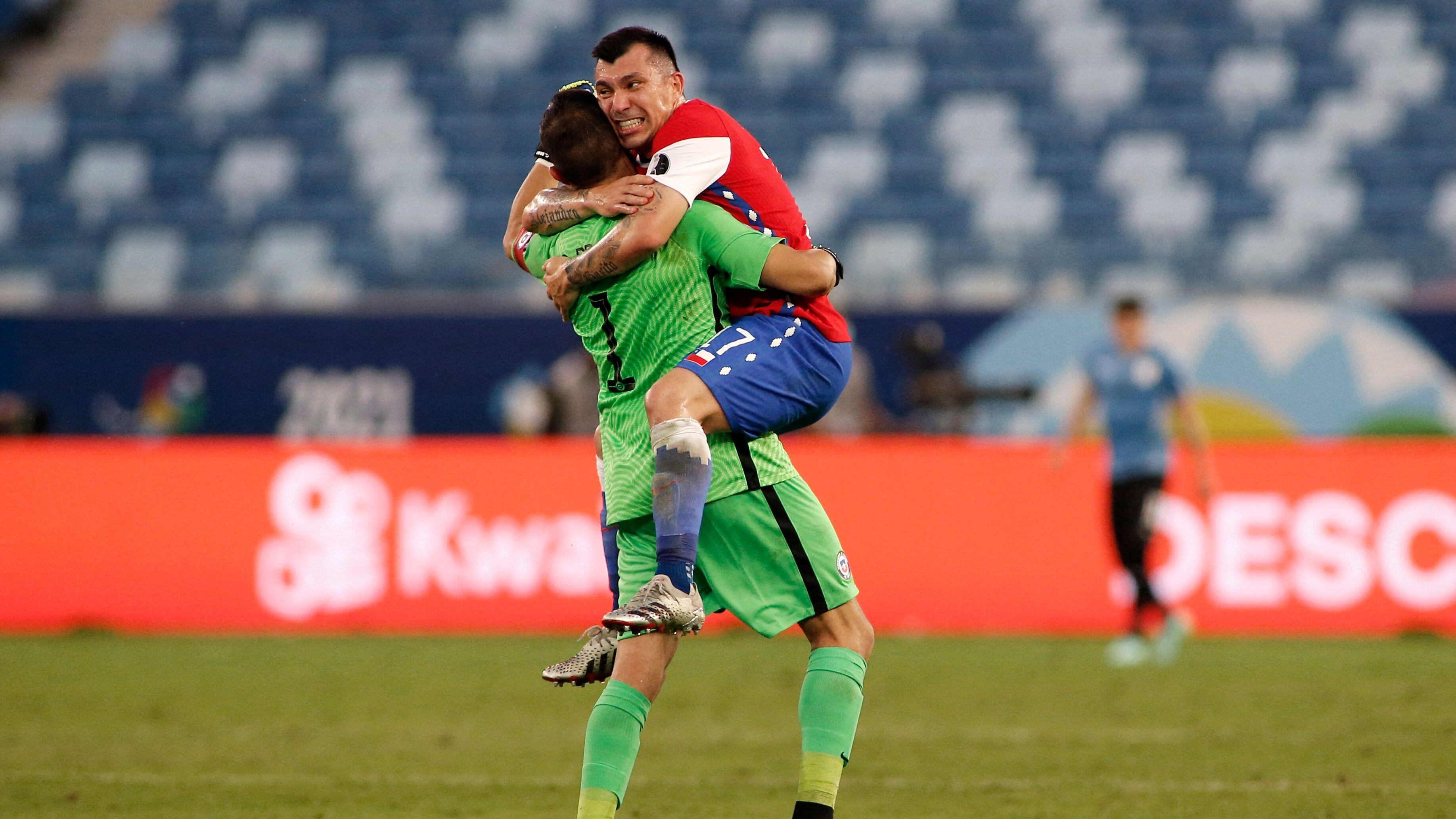 Chile's goalkeeper Claudio Bravo and Chile's Gary Medel celebrate after teammate Eduardo Vargas (out of frame) scored against Uruguay during their Conmebol Copa America 2021 football tournament group phase match at the Pantanal Arena in Cuiaba, Brazil, on June 21, 2021. (Photo by SILVIO AVILA / AFP) (Photo by SILVIO AVILA/AFP via Getty Images)