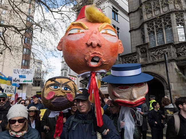 LONDON, UNITED KINGDOM - MARCH 28, 2026: Demonstrators hold papier mache heads depicting US Vice President JD Vance, US President Donald Trump and First Lady Melania Trump during a protest against Donald Trump administration's immigration enforcement tactics and the war in Iran ahead of Together Alliance March Against the Far Right in London, United Kingdom on March 28, 2026. The demonstration is part of a global day of action with events taking place at more than 3,000 locations, as US citizens and others protest against what the organisers desribe as authoritarian actions of the Trump adiministration. (Photo credit should read Wiktor Szymanowicz/Future Publishing via Getty Images)