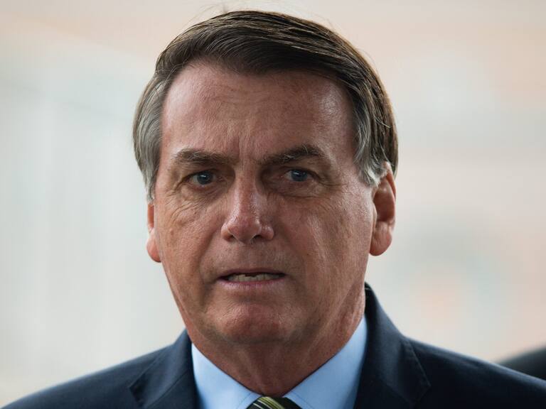 BRASILIA, BRAZIL - MARCH 25: Brazilian President Jair Bolsonaro looks on during a press conference amidst the coronavirus (COVID - 19) pandemic at the Palacio do Alvorada on March, 25, 2020 in Brasilia, Brazil. Bolsonaro recently defended the nation's return to normality and the end of social distancing and quarantine. According to the Ministry of health, as today, Brazil has 2271 confirmed cases infected with the coronavirus (COVID-19) and at least 47 recorded deceases.(Photo by Andressa Anholete / Getty Images)