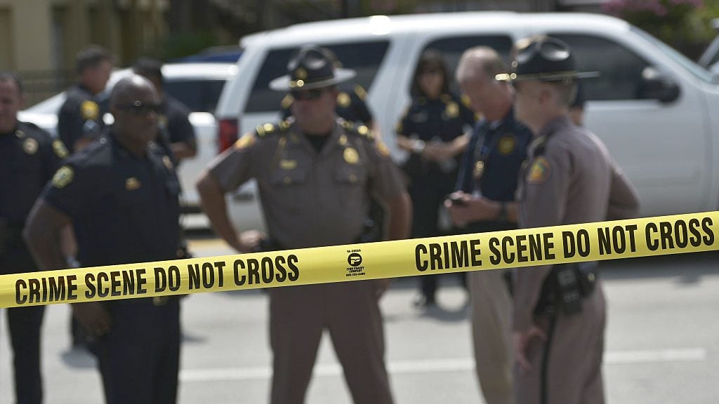 TOPSHOT - Police stand behind a crime scene tape near the mass shooting at the Pulse nightclub on in Orlando, Florida on June 12, 2016.A somber President Barack Obama  expressed grief and outrage at the "horrific massacre" of 50 late-night revelers at an Orlando gay club, branding it an act of terror and hate. / AFP / Mandel Ngan        (Photo credit should read MANDEL NGAN/AFP via Getty Images)