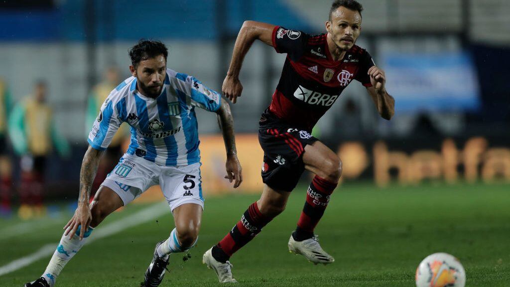 AVELLANEDA, ARGENTINA - NOVEMBER 24: Eugenio Mena of Racing Club  fights for the ball with Rene of Flamengo during a round of sixteen first leg match between Racing Club and Flamengo at Presidente Peron Stadium on November 24, 2020 in Avellaneda, Argentina. (Photo by Juan Ignacio Roncoroni - Pool/Getty Images)