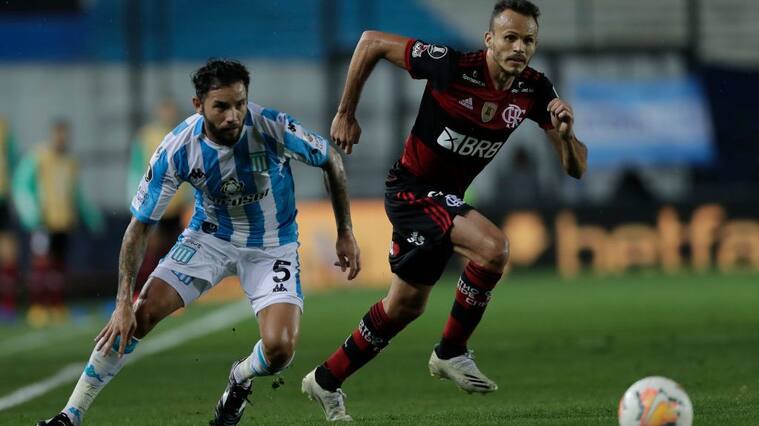 AVELLANEDA, ARGENTINA - NOVEMBER 24: Eugenio Mena of Racing Club fights for the ball with Rene of Flamengo during a round of sixteen first leg match between Racing Club and Flamengo at Presidente Peron Stadium on November 24, 2020 in Avellaneda, Argentina. (Photo by Juan Ignacio Roncoroni - Pool/Getty Images)