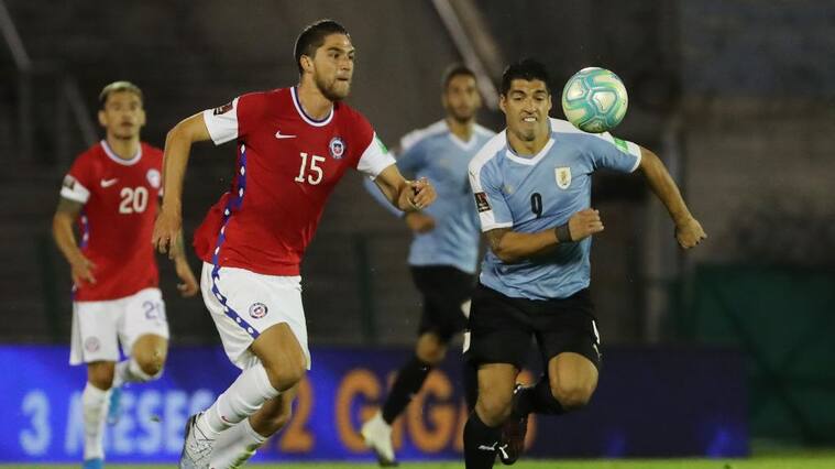 MONTEVIDEO, URUGUAY - OCTOBER 08: Luis Suarez of Uruguay fights for the ball with Francisco Sierralta of Chile during a match between Uruguay and Chile as part of South American Qualifiers for Qatar 2022 at Centenario Stadium on October 08, 2020 in Montevideo, Uruguay. (Photo by Raul Martinez -Pool/Getty Images)