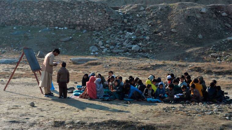 TOPSHOT - School children take part in a lesson in an open-air classroom in Qarghayi district of Laghman Province on January 20, 2020. (Photo by NOORULLAH SHIRZADA / AFP) (Photo by NOORULLAH SHIRZADA/AFP via Getty Images)
