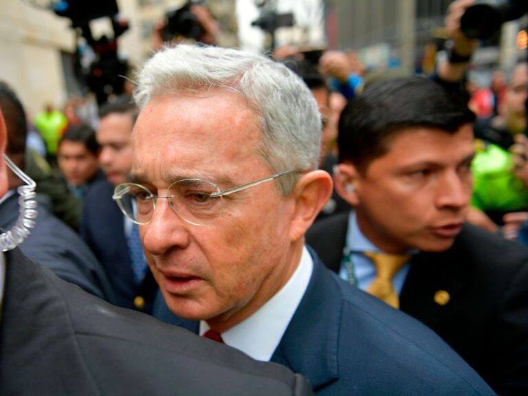 Former Colombian President (2002-2010) and Senator Alvaro Uribe (C) arrives to the Palace of Justice for a hearing before the Supreme Court of Justice in a case over witness tampering in Bogota, Colombia, on October 8, 2019. - The influential ex-president and senator Alvaro Uribe, head of the ruling party in Colombia, appears before the Supreme Court of Justice, for an alleged case of witness manipulation. (Photo by Raul ARBOLEDA / AFP) (Photo by RAUL ARBOLEDA/AFP via Getty Images)