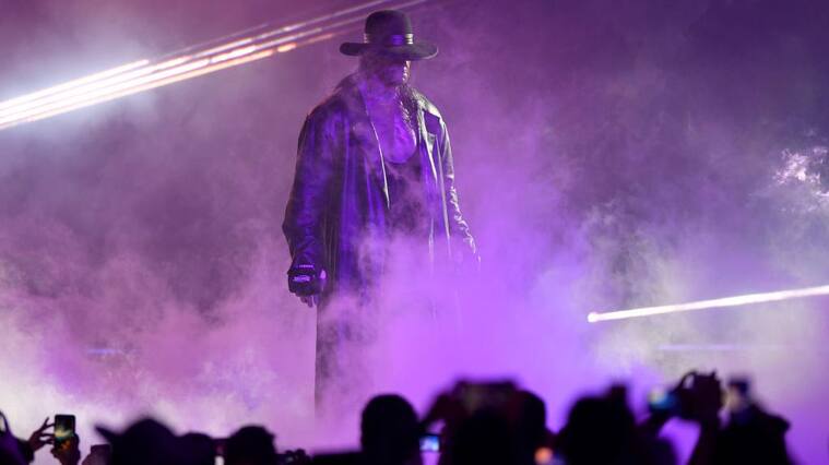 TOPSHOT - World Wrestling Entertainment star The Undertaker makes his way to the ring during a match at the World Wrestling Entertainment (WWE) Super Showdown event in the Saudi Red Sea port city of Jeddah late on January 7, 2019. (Photo by Amer HILABI / AFP) (Photo credit should read AMER HILABI/AFP via Getty Images)