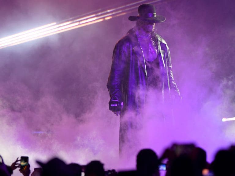 TOPSHOT - World Wrestling Entertainment star The Undertaker makes his way to the ring during a match at the World Wrestling Entertainment (WWE) Super Showdown event in the Saudi Red Sea port city of Jeddah late on January 7, 2019. (Photo by Amer HILABI / AFP)        (Photo credit should read AMER HILABI/AFP via Getty Images)