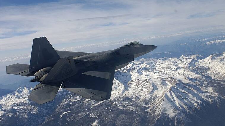 IN FLIGHT - NOVEMBER 23: The United States Air Force's F/A-22 Raptor, which will replace the F-15 bomber and is the first supersonic stealth fighter plane ever created flys over the Sierra Nevada Mountains November 23, 2002 in Northern California. The Raptor is said to be the most advanced plane ever designed and will be fully operational by 2005. Onboard is the new generation of smart computers that have made its advances possible. Whereas, for example, the Saturn V Rocket of 1967 had a computer onboard that ran on sixteen thousand lines of code, the Raptor's computer is programmed with two million lines of code. Because it stores it missiles and fuel inside its body, moreover, it has exceptionally low aerodynamic drag. Add to this low drag the fact that it is virtually impossible to detect the Raptor by radar until it is too close to fire on, and it is safe to say that the Raptor gives the US doiminance in the skies. Each plane has over one million parts and it takes one thousand Lockheed Martin technicians one month to build one in their facilities in Marietta, Georgia. With the Wright Brothers' historic flight celebrating its centennial in 2003, the world is now poised on the threshold of a new age in aviation, one where super-sonic jets refuel in flight, unmanned aerial vehicles track objects with astonishing accuracy, and airliners are maneuvered at times with minimal human participation. The computer age is about to revolutionize aviation and the United States is unquestionably ahead of the curve in this revolution. (Photo by Joe McNally/Getty Images)