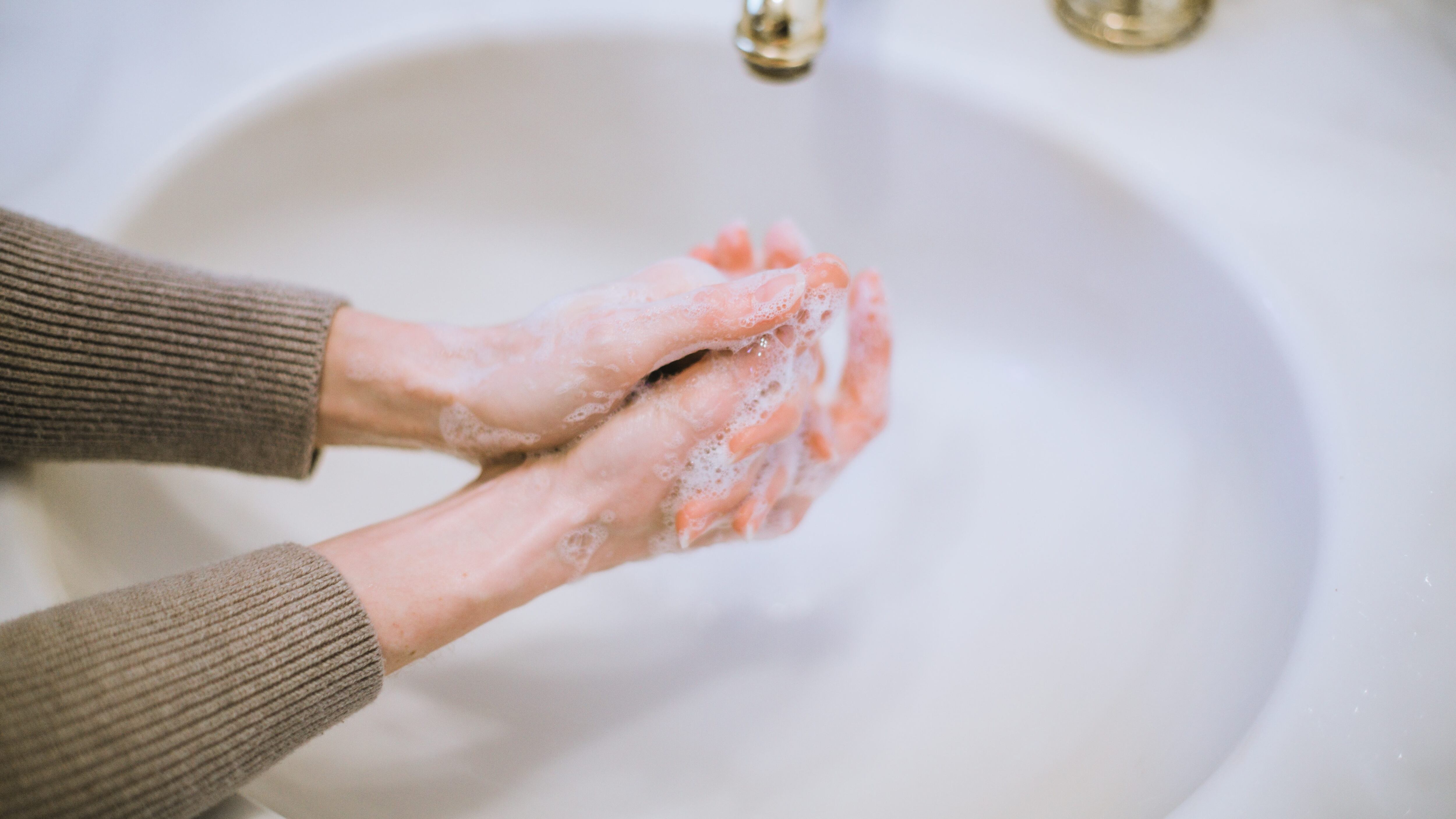 Woman washing hands, hand washing, germaphobe, OCD, health anxiety, good hygiene, prevention, preventing spread of germs, bacteria and viruses, like Coronavirus.