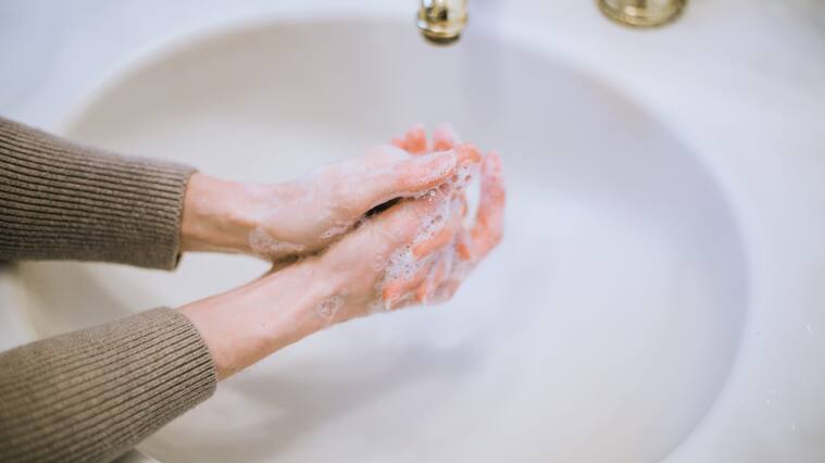Woman washing hands, hand washing, germaphobe, OCD, health anxiety, good hygiene, prevention, preventing spread of germs, bacteria and viruses, like Coronavirus.