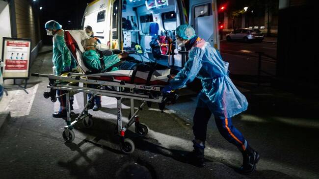 TOPSHOT - French first aid workers from the Protection Civile Paris Seine, wearing personal protection equipment (PPE) push a male patient on a gurney, suspected of being infected with COVID-19, into a hospital, as Paris and the rest of the nation experiences a coronavirus outbreak on April 3, 2020. - France has been on lockdown since March 17 in a bid to limit the contagion caused by the novel coronavirus, a situation it has extended until at least April 15. (Photo by Lucas BARIOULET / AFP) (Photo by LUCAS BARIOULET/AFP via Getty Images)