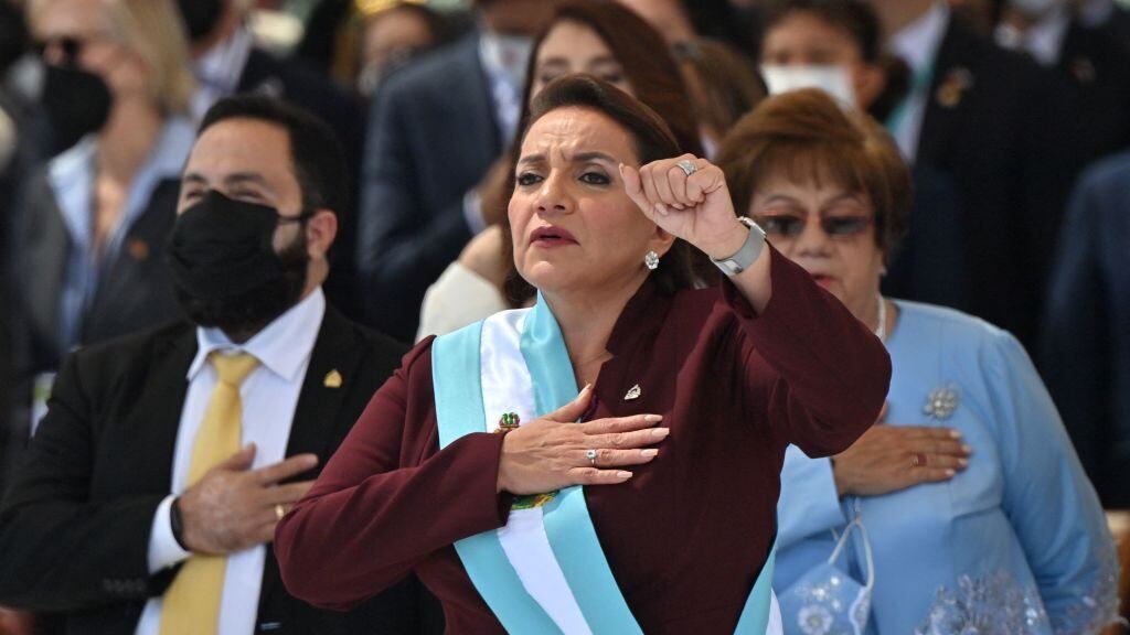 Honduran president-elect Xiomara Castro holds up her clenched fist as she wears the presidential sash after swearing in during her inauguration ceremony, in Tegucigalpa, on January 27, 2022. - Honduras president-elect Xiomara Castro swore in as the country's first woman president on Thursday, as confusion reigns over who will be head of congress during her four-year term. (Photo by Luis Acosta / AFP) (Photo by LUIS ACOSTA/AFP via Getty Images)