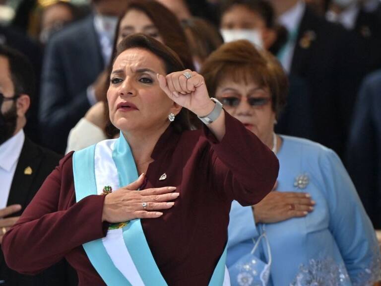 Honduran president-elect Xiomara Castro holds up her clenched fist as she wears the presidential sash after swearing in during her inauguration ceremony, in Tegucigalpa, on January 27, 2022. - Honduras president-elect Xiomara Castro swore in as the country's first woman president on Thursday, as confusion reigns over who will be head of congress during her four-year term. (Photo by Luis Acosta / AFP) (Photo by LUIS ACOSTA/AFP via Getty Images)