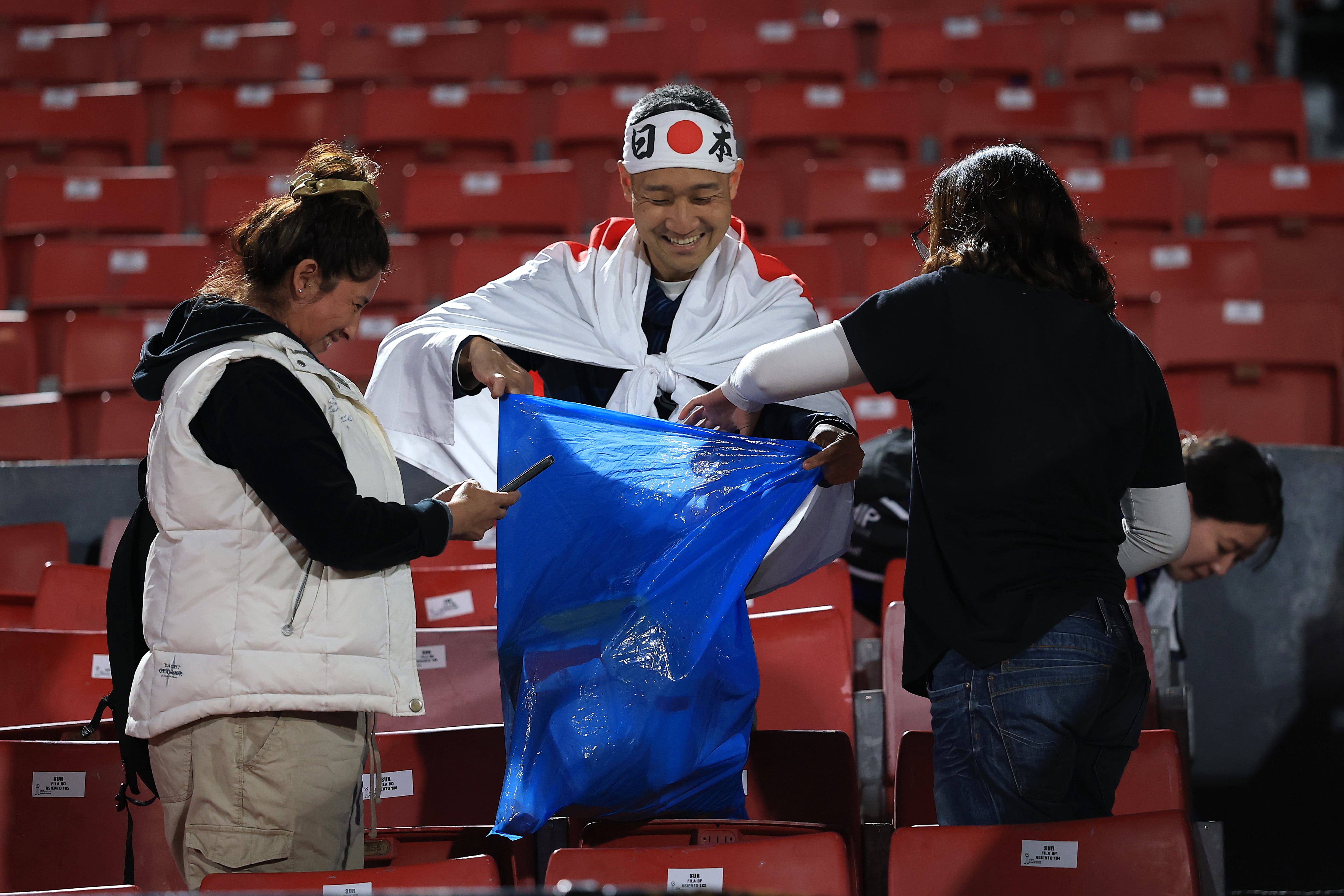 SANTIAGO, CHILE - SEPTEMBER 30: Fans of Japan cleaning the stadium after the FIFA U-20 World Cup Chile 2025 Group A match between Chile and Japan at Estadio Nacional Julio Martínez Prádanos on September 30, 2025 in Santiago, Chile. (Photo by Buda Mendes - FIFA/FIFA via Getty Images)