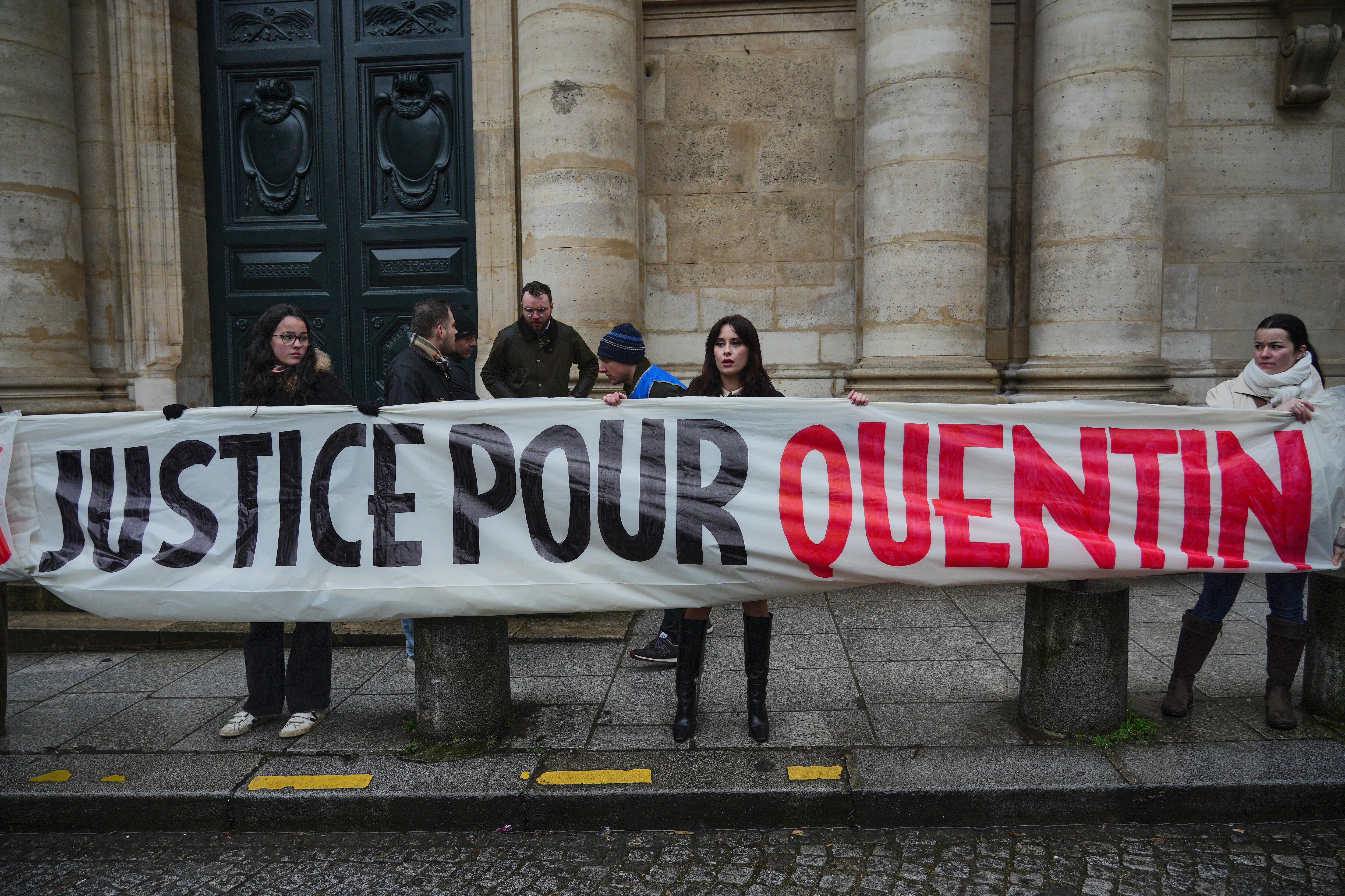 PARIS, FRANCE - FEBRUARY 15: Women are seen holding a banner with the text "Justice for Quentin" during a vigil. (Photo by Remon Haazen/Getty Images)