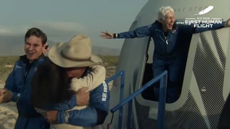 VAN HORN, TEXAS - JULY 20: (----EDITORIAL USE ONLY â MANDATORY CREDIT - "BLUE ORIGIN / HANDOUT" - NO MARKETING NO ADVERTISING CAMPAIGNS - DISTRIBUTED AS A SERVICE TO CLIENTS----) Jeff Bezos along with his brother Mark Bezos, 18-year-old Oliver Daemen, and 82-year-old Wally Funk leave Blue Originâs New Shepard crew capsule after landing on July 20, 2021 in Van Horn, Texas. Mr. Bezos and the crew rode in the first human spaceflight for the company. (Photo by Blue Origin/Anadolu Agency via Getty Images)
