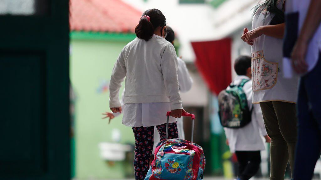 BUENOS AIRES, ARGENTINA - FEBRUARY 17: Schoolchildren enter the Provincia de Cordoba school on February 17, 2021 in Buenos Aires, Argentina. Students of the first years of elementary and secondary school, representing 47% of the total, resume on site lessons after one year of home schooling due to coronavirus pandemic. The rest of the students will return on the following weeks. Government announced strict protocols to prevent spread of the virus. (Photo by Marcos Brindicci/Getty Images)