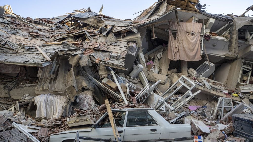 ELAZIG, TURKEY - JANUARY 25: A car stuck in the rubble after a 6.8-magnitude earthquake jolted eastern Turkish province of Elazig on January 25, 2020. Search and rescue efforts are underway after a deadly earthquake rattled eastern Turkey, killing at least 20 people and injuring more than 1,015 others, according to authorities (Photo by Ali Balikci/Anadolu Agency via Getty Images)