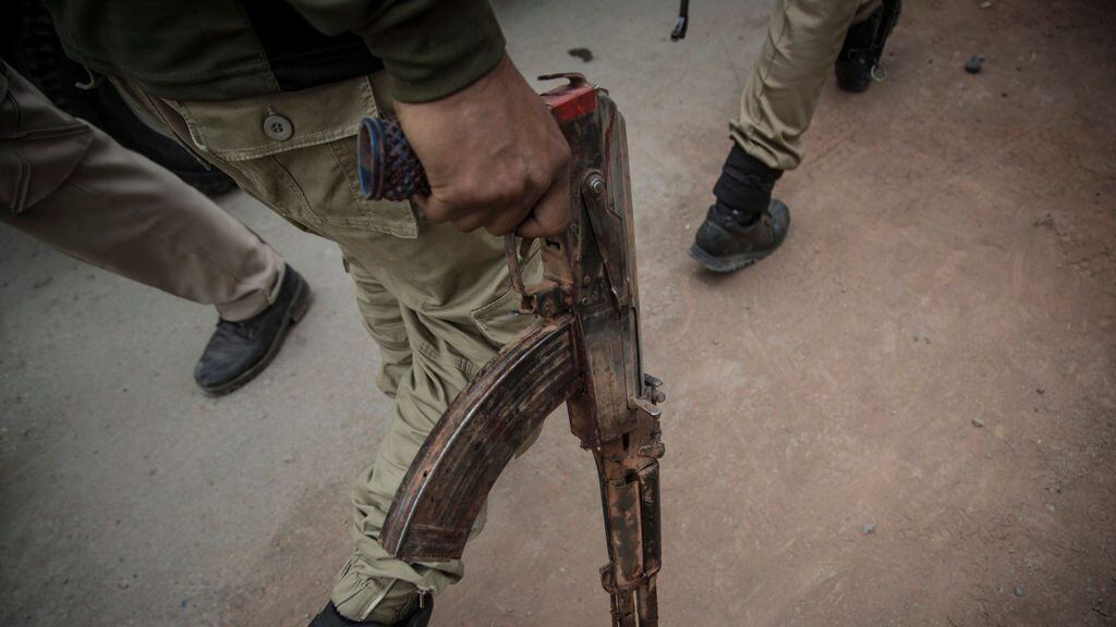 A recovered AK47 gun of the suspected rebel from the gunfight site is taken away by an Indan policeman Saturday, May 5, 2018, in Srinagar, Indian-controlled Kashmir. Three rebels were killed in a gunfight with the Indian troops Saturday in the main city in Indian-controlled Kashmir, officials said. A civilian was crushed to death by the government forces vehicle near the gunfight site. (Photo by Ahmer Khan/NurPhoto via Getty Images)