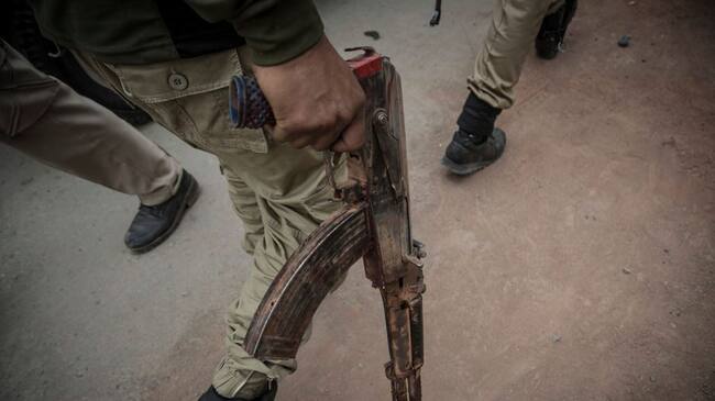 A recovered AK47 gun of the suspected rebel from the gunfight site is taken away by an Indan policeman Saturday, May 5, 2018, in Srinagar, Indian-controlled Kashmir. Three rebels were killed in a gunfight with the Indian troops Saturday in the main city in Indian-controlled Kashmir, officials said. A civilian was crushed to death by the government forces vehicle near the gunfight site. (Photo by Ahmer Khan/NurPhoto via Getty Images)