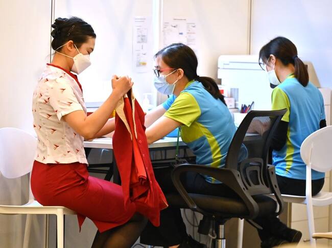 Trabajadora de la salud vacuna a una mujer en Hong Kong