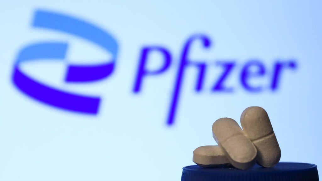 Medicine pills are seen with Pfizer logo displayed on a screen in the background in this illustration photo taken in Krakow, Poland on April 27, 2021. (Photo Illustration by Jakub Porzycki/NurPhoto via Getty Images)