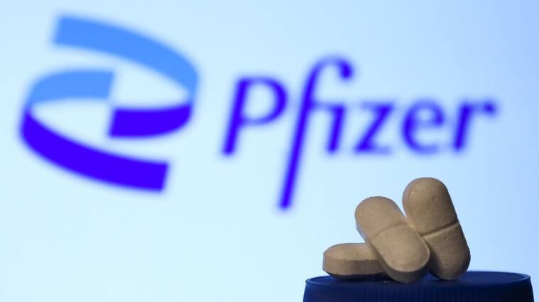 Medicine pills are seen with Pfizer logo displayed on a screen in the background in this illustration photo taken in Krakow, Poland on April 27, 2021. (Photo Illustration by Jakub Porzycki/NurPhoto via Getty Images)