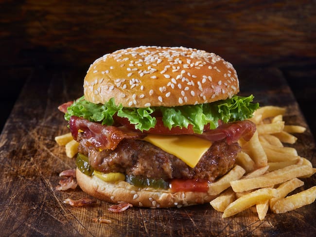 Grilled Juicy Ground PORK and Bacon Cheeseburger with Lettuce, Tomato, Pickles, Ketchup, Mustard and Fries