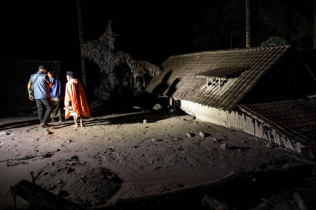 Rescatistas evalúan cómo excavar en una vivienda cubierta por desechos volcánicos en Indonesia