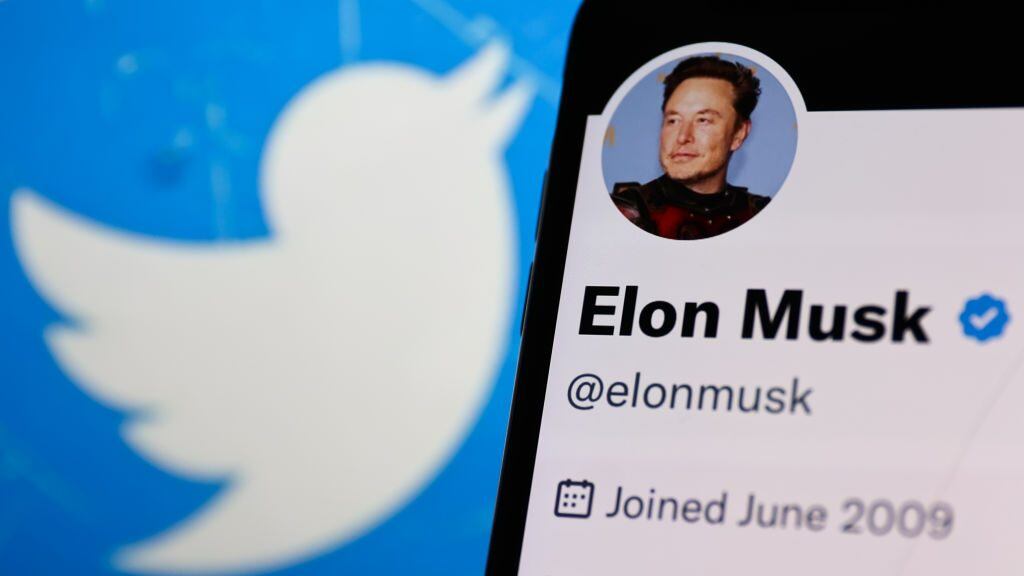 Elon Musk account on Twitter displayed on a phone screen and Twitter logo displayed on a laptop screen are seen in this illustration photo taken in Krakow, Poland on November 14, 2022. (Photo by Jakub Porzycki/NurPhoto via Getty Images)