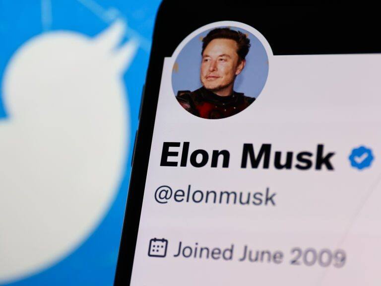 Elon Musk account on Twitter displayed on a phone screen and Twitter logo displayed on a laptop screen are seen in this illustration photo taken in Krakow, Poland on November 14, 2022. (Photo by Jakub Porzycki/NurPhoto via Getty Images)