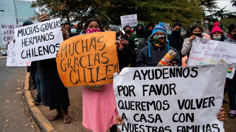 Stranded Bolivian citizens remain at a makeshift camp in front of Bolivia's consulate in Santiago, on June 02, 2020 waiting for a solution to their situation as the borders were closed due to the coronavirus COVID-19 pandemic. (Photo by Martin BERNETTI / AFP) (Photo by MARTIN BERNETTI/AFP via Getty Images)