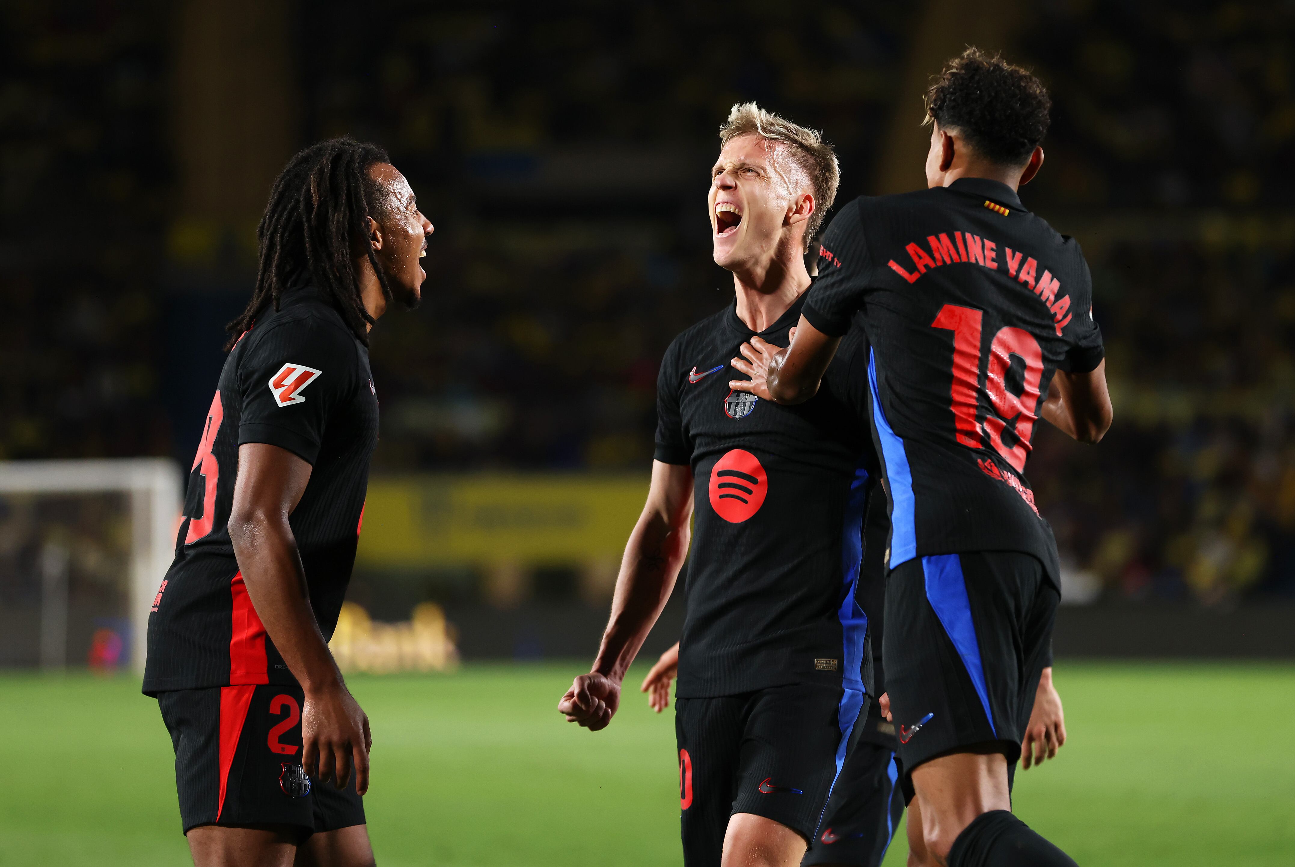 LAS PALMAS, SPAIN - FEBRUARY 22: Dani Olmo of FC Barcelona celebrates with his team mates Jules Kounde and Lamine Yamal after scoring his team's first goal during the LaLiga match between UD Las Palmas and FC Barcelona at Estadio Gran Canaria on February 22, 2025 in Las Palmas, Spain. (Photo by Florencia Tan Jun/Getty Images)